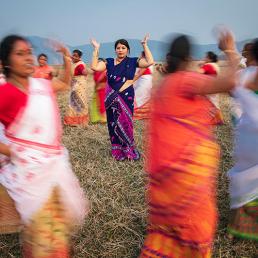 Purnima Devi Barman seen in the middle of a group of women dancing, the "Hargila Army"