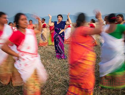 Purnima Devi Barman seen in the middle of a group of women dancing, the "Hargila Army"