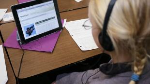 Student in classroom listening to BirdNote